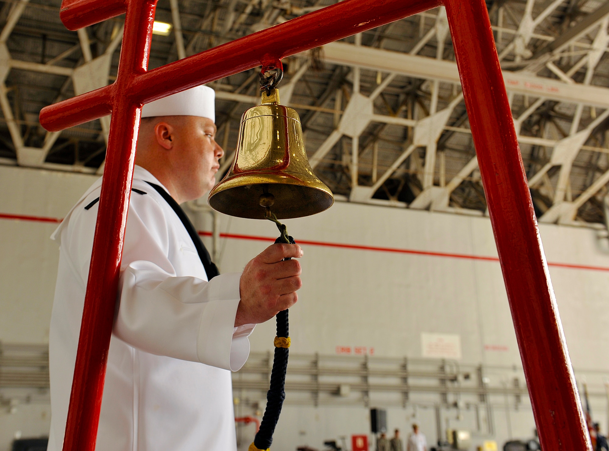 U.S. Navy Yeoman 1st Class Richard Espinosa, Patrol Squadron Forty bell ringer, rings a bell during a change of command ceremony, June 2, 2016, at Kadena Air Base, Japan. During the ceremony, Cmdr. Aaron Shoemaker was relieved by Cmdr. Timothy Thompson as commander of Patrol Squadron Forty. (U.S. Air Force photo by Naoto Anazawa)