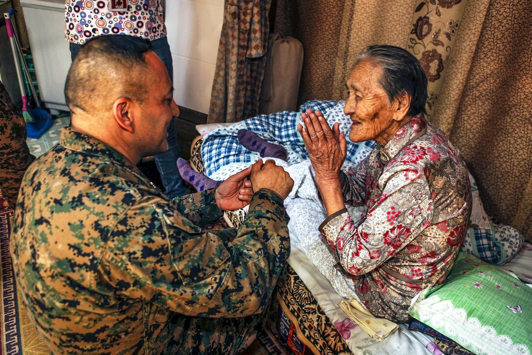 Navy Cmdr. Adolfo Granados provides medical care during a home visit as part of Health Services Support Engagement for Khaan Quest 2016 in Ulaanbaatar, Mongolia, May 26, 2016. The annual, multinational exercise focuses on peacekeeping operations. Granados is a group surgeon assigned to 3rd Marine Logistics Group. Marine Corps photo by Cpl. Hilda M. Becerra