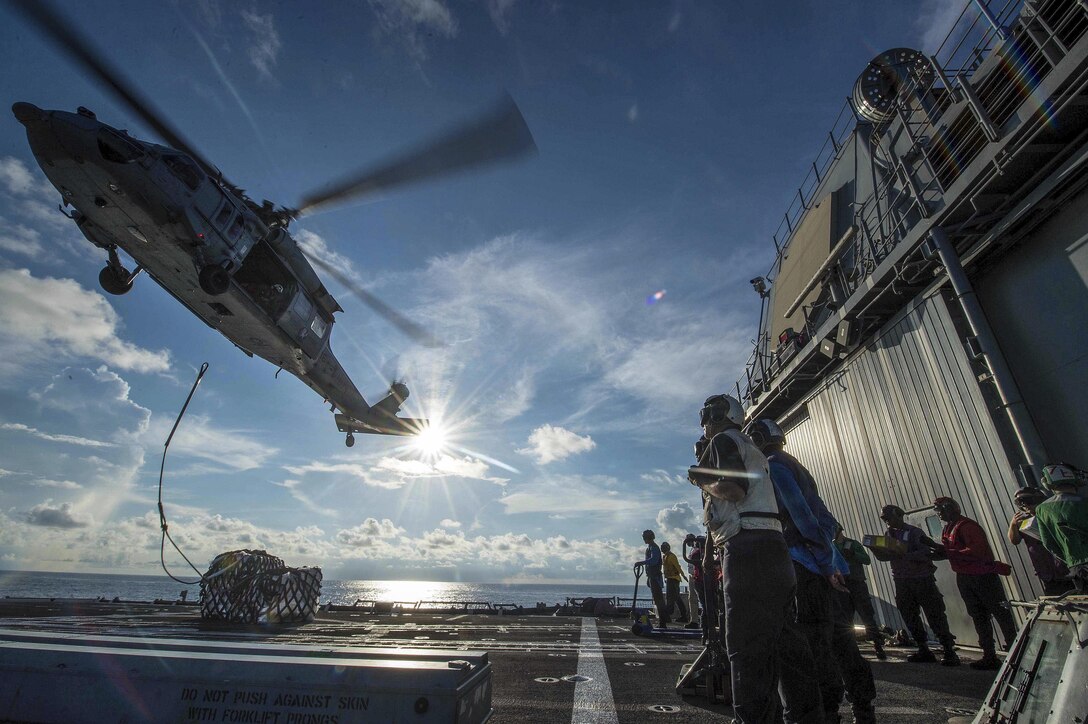 Sailors aboard the USS Mobile Bay receive two of 21 pallets from an MH-60S Seahawk helicopter during a vertical replenishment in the South China Sea, May 29, 2016. The guided-missile cruiser supports security and stability in the Indo-Asia-Pacific region. Navy photo by Petty Officer 2nd Class Ryan J. Batchelder