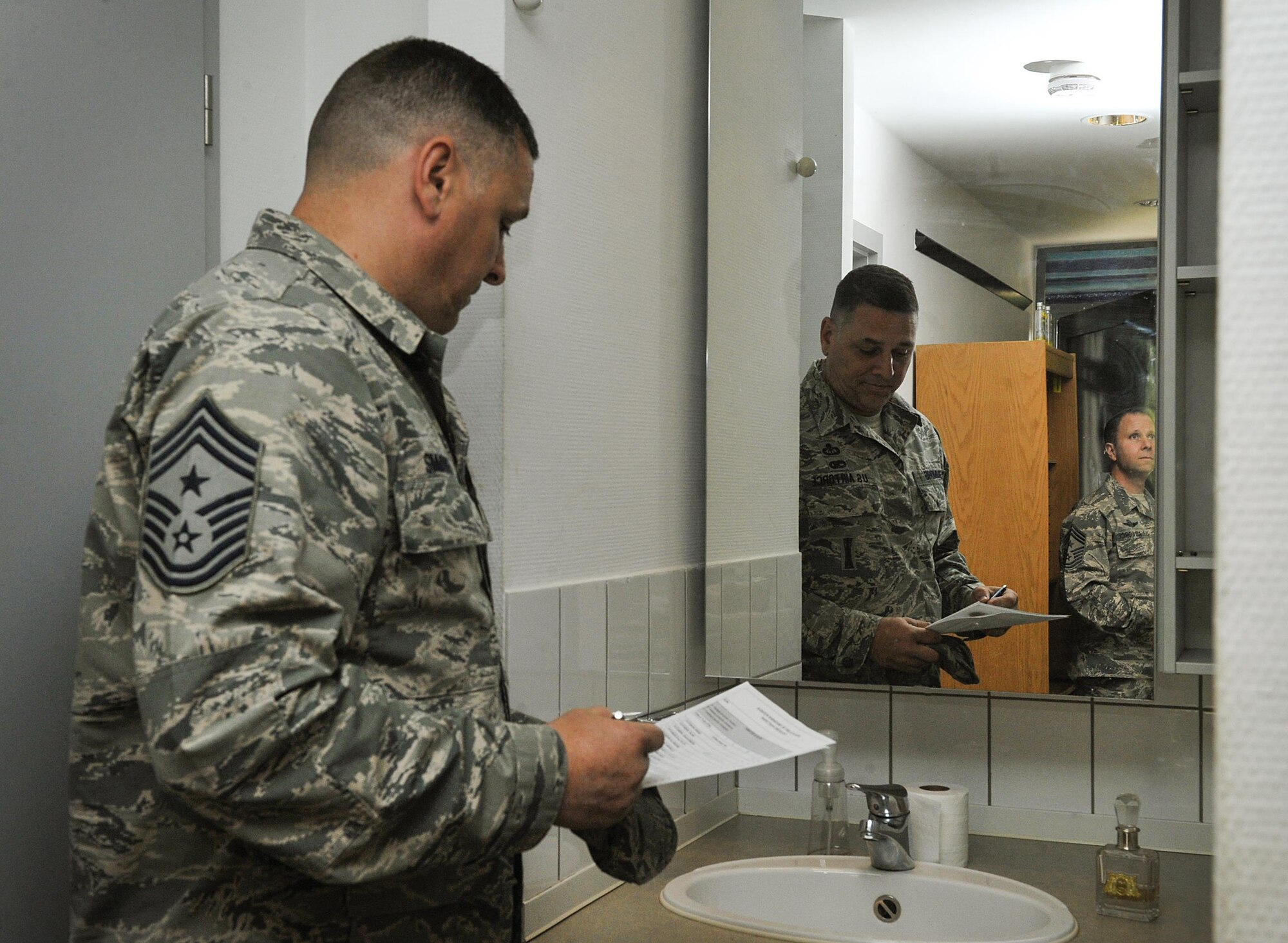 Chief Master Sgt. Todd Simmons, 435th Air Ground Operations Wing command chief, inspects an Airman’s room May 17, 2016, at Ramstein Air Base, Germany. For Ramstein’s first dorm of the quarter award, the first place dorm building received a $1,000 budget and the second place winners earned $500 to go toward whatever the residents agree upon to maintain or better their living quarters. (U.S. Air Force photo/Senior Airman Larissa Greatwood)