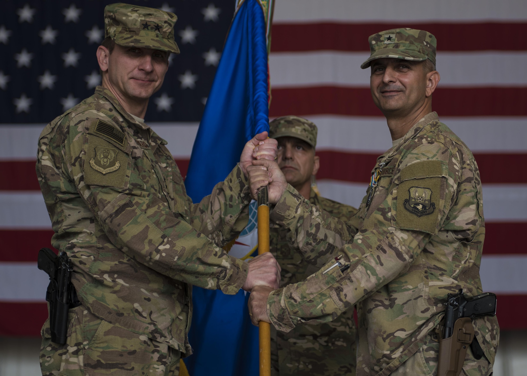 Brig. Gen. David Julazadeh (right), 455th Air Expeditionary Wing commander, hands the guidon to Maj. Gen. Geffrey Taliaferro (left), 9th Air and Space Expeditionary Task Force-Afghanistan commander, during a change of command ceremony at Bagram Airfield, Afghanistan, June 03, 2016. A guidon is a military standard that company or platoon-sized elements carry to signify their unit designation and corps affiliation or the title of the individual who carries it. (U.S. Air Force photo by Senior Airman Justyn M. Freeman)