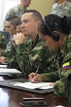 Seven members of the Colombian military meet with the University of South Carolina's Rule of Law Collaborative in Columbia, S.C., May 23, during a Subject Matter Expert Exchange with the South Carolina National Guard's State Partnership Program. The week-long information exchange with Colombian military and National Police legal experts focused on human rights and operational law.