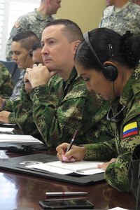 Seven members of the Colombian military meet with the University of South Carolina's Rule of Law Collaborative in Columbia, S.C., May 23, during a Subject Matter Expert Exchange with the South Carolina National Guard's State Partnership Program. The week-long information exchange with Colombian military and National Police legal experts focused on human rights and operational law.