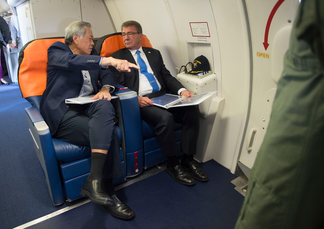 Defense Secretary Ash Carter discusses the capabilities of a P-8 with  Singaporean Defense Minister Ng Eng Hen during a flight over Singapore and the Strait of Malacca, June 3, 2016. Carter is in Singapore attending the 15th International Institute for Strategic Studies Asia Security Summit. DoD photo by Navy Petty Officer 1st Class Tim D. Godbee