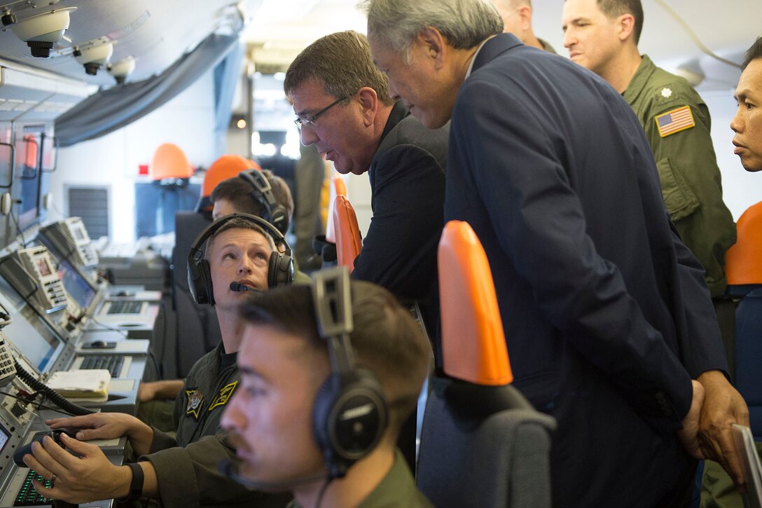 Defense Secretary Ash Carter and Singaporean Defense Minister Ng Eng Hen are briefed on the capabilities of a P-8 during a flight over Singapore and the Strait of Malacca, June 3, 2016. Carter is in Singapore attending the Shangri-La Dialogue. DoD photo by Navy Petty Officer 1st Class Tim D. Godbee