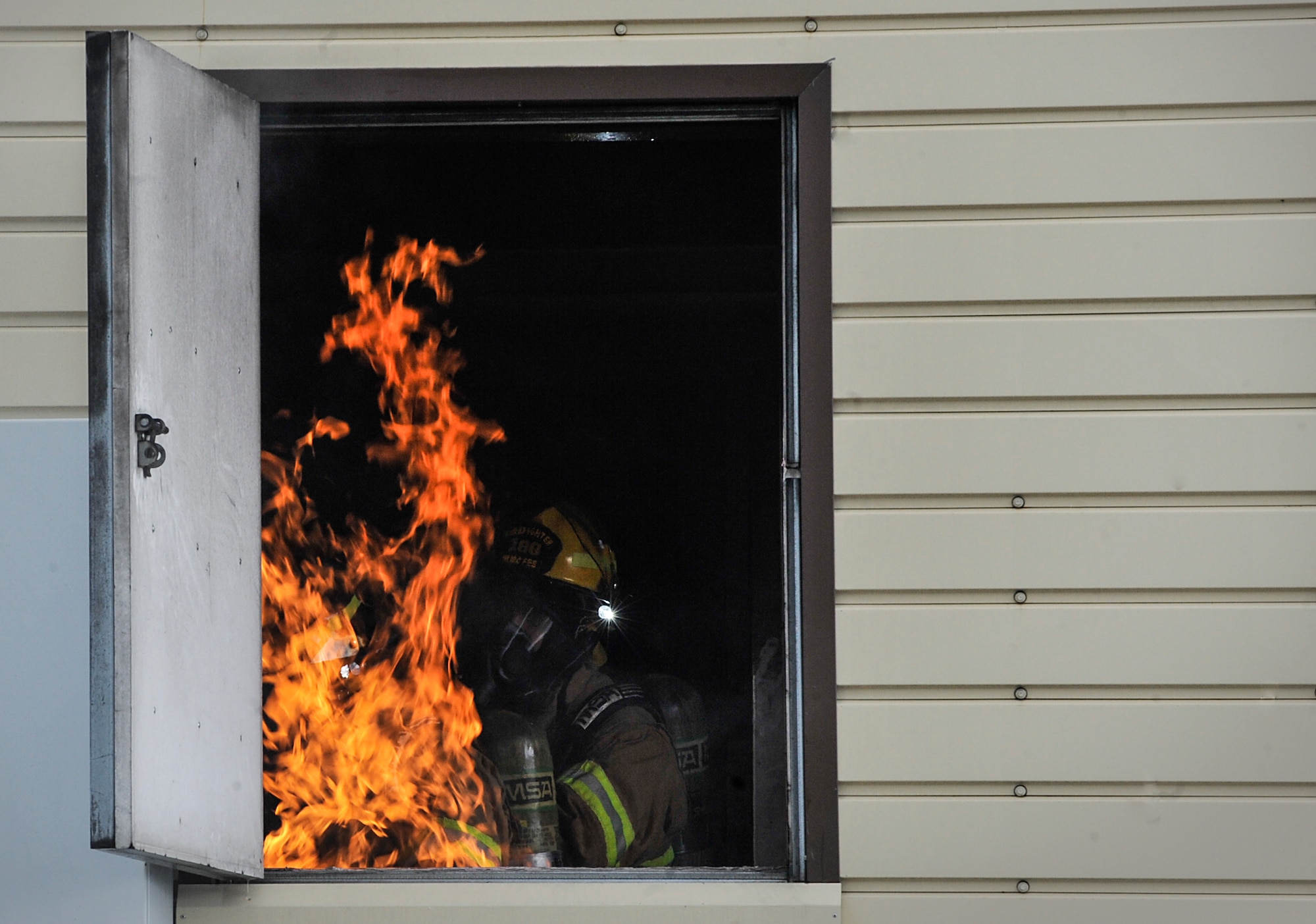 Airmen from the 86th Civil Engineer Squadron put out a fire during a biannual training exercise June 2, 2016, at Ramstein Air Base, Germany. These exercises prepare Airmen for real-world fires and emergencies. (U.S. Air Force photo/Senior Airman Larissa Greatwood)