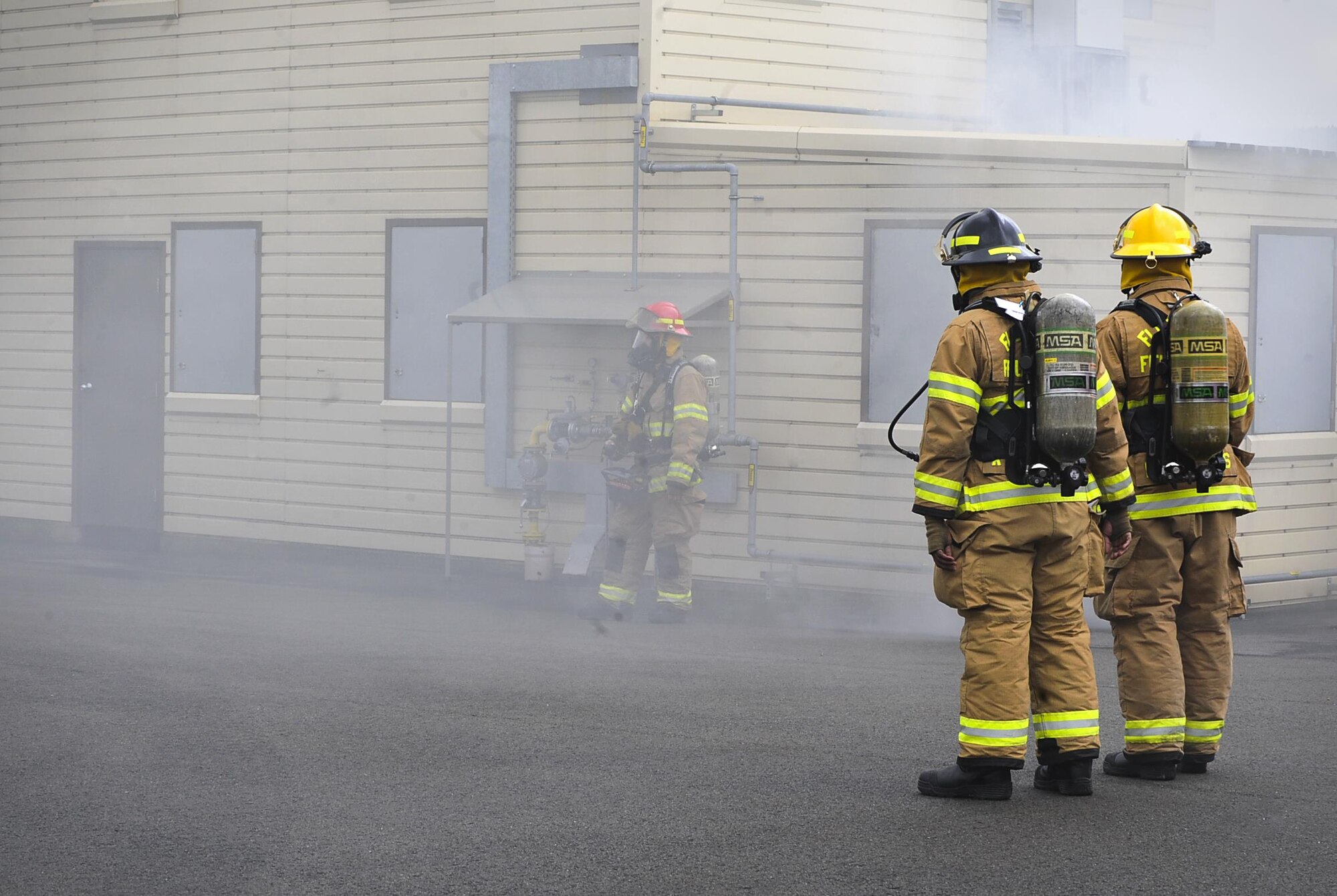 Airmen from the 86th Civil Engineer Squadron prepare to enter a simulated burning house during a biannual-training exercise June 2, 2016, at Ramstein Air Base, Germany. The 86th CES Airmen provide fire emergency services to Ramstein Air Base, Vogelweh Military Complex, Rhine Ordinance Barracks and Landstuhl military sites (U.S. Air Force photo/Senior Airman Larissa Greatwood)