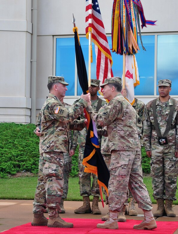 Lt. Gen. Jeffrey W. Talley, commanding general for U.S. Army Reserve Command, relinquishes the command flag to Gen. Robert Abrams, commanding general of U.S. Army Forces Command during a relinquishment of command ceremony held outside Marshall Hall at Fort Bragg, N.C. on 1 Jun.