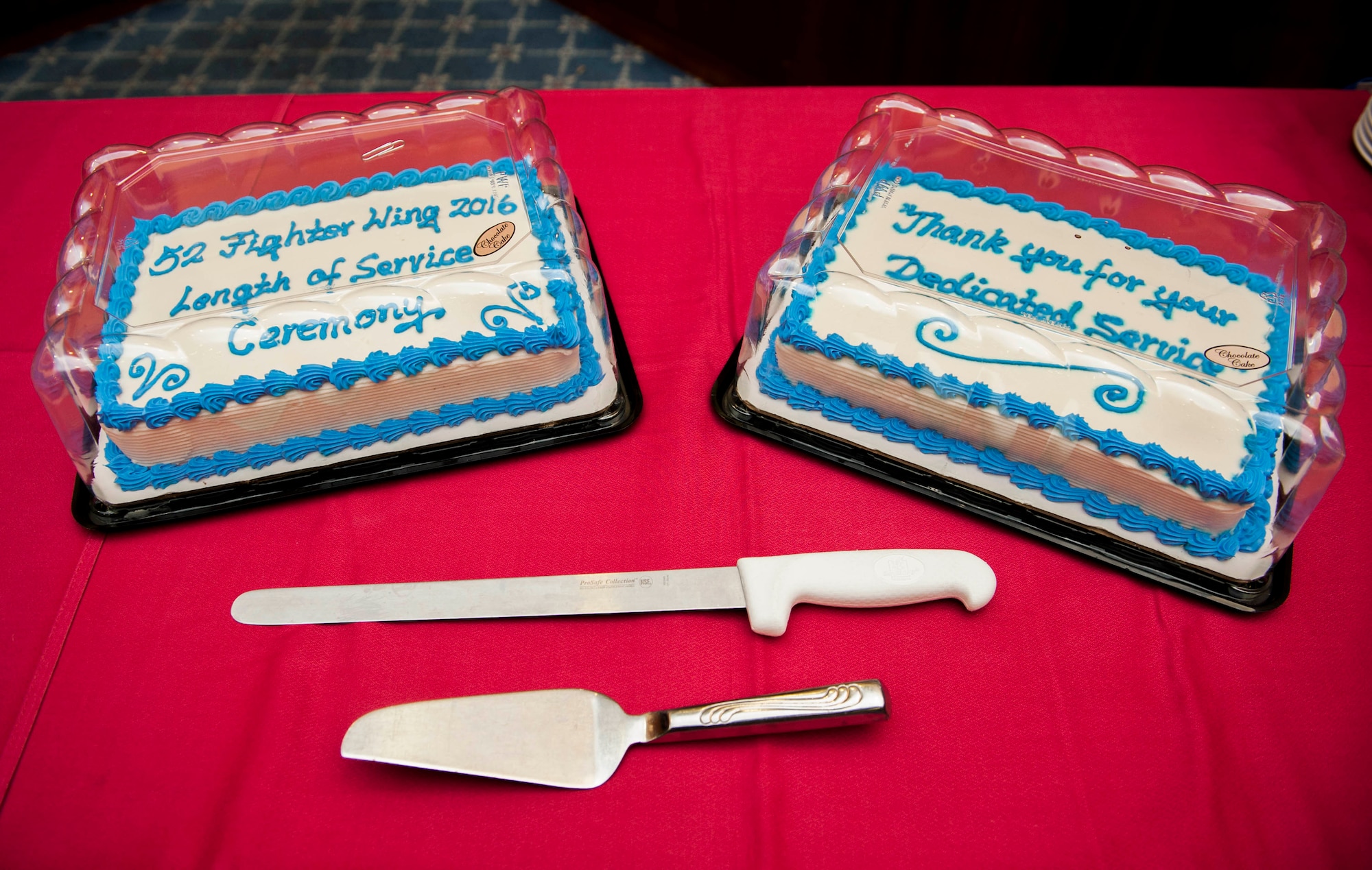 Two cakes lie on top of a table during the Length of Service recognition ceremony in Club Eifel at Spangdahlem Air Base, Germany, June 3, 2016. The ceremony recognized the years of service the installation’s civilian work force have dedicated. (U.S. Air Force photo by Airman 1st Class Timothy Kim/Released)