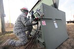 Spec. Arnold Wicker of the 249th Engineer Battalion (Prime Power) attaches cables to a power transfer box while installing generators at a Carteret, New Jersey power plant that lost power during Hurricane Sandy Nov. 6, 2012. DLA provided additional power generators to the Federal Emergency Management Agency to aid in the recovery effort.
