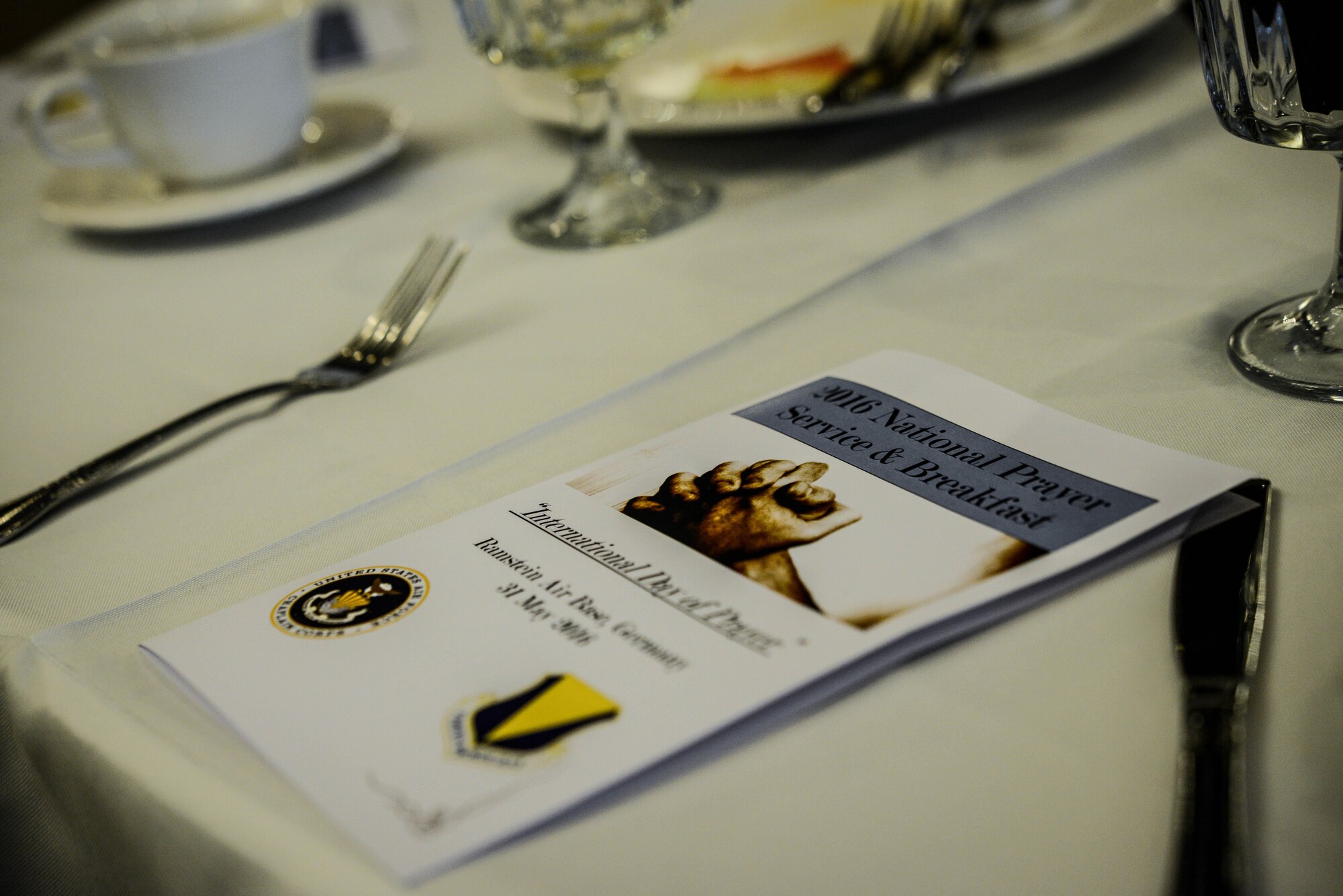 A flyer for the 2016 National Prayer Service Breakfast is placed on a table May 31, 2016, Ramstein Air Base, Germany. Maintaining the pillars of RU Fit, is a priority for Airmen around the Air Force and gatherings like this are just one way they build a strong foundation to stay mission-ready. (U.S. Air Force photo/Senior Airman Nicole Keim) 