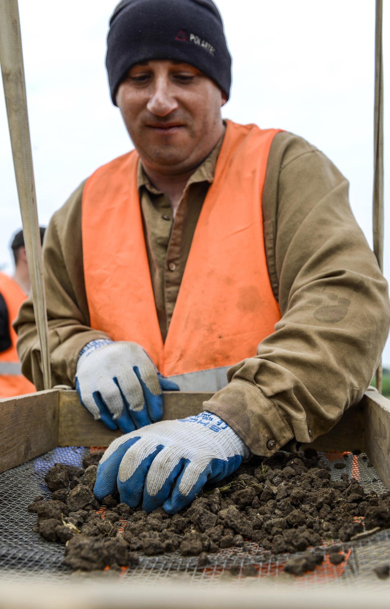 U.S. Army Sgt. 1st Class Joseph Stoner, NCO in charge of Mortuary Affairs, 16th Sustainment Brigade, 21st Theater Sustainment Command, screens a bucket of dirt at a recovery site in eastern Germany, May 18, 2016. As an augmentee of the Defense POW/MIA Accounting Agency, Stoner was tasked to help search for personnel who went missing in action from World War II. (U.S. Air Force photo/Staff Sgt. Timothy Moore)