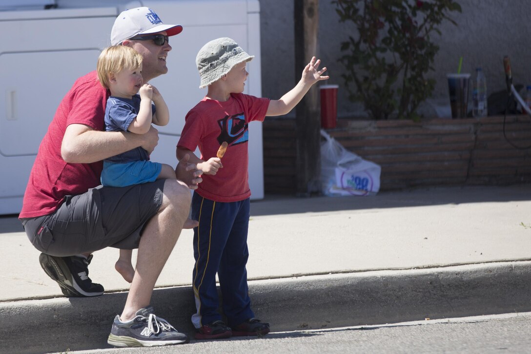 Parade spectators wave to Combat Center Marines during the annual Grubstake Days Parade in Yucca Valley, Calif., May 28, 2016. The parade was held as part of Yucca Valley’s Annual Grubstake Days, a festival held to embrace the mining heritage of the Yucca Valley community. (Official Marine Corps photo by Cpl. Medina Ayala-Lo/Released)