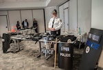 DLA Columbus Police Division Watch Commander Edward Compton Jr. stands behind a display of tactical police tools and equipment May 18. Also on display is a collection of contraband which police officers prevented from entering the installation. The displays are a part of week-long activities to celebrate Police Week.