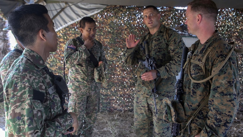 U.S. Marine Corps First Sgt. Benjamin Zeigler, the company first sergeant assigned to Echo Company, Battalion Landing Team, 2nd Battalion, 2nd Marine Regiment, middle right, explains the capabilities of a Marine Corps rifle squad to service members of the Royal Malay Army after an amphibious transition from ship to shore at Tanduo Beach, Malaysia, May 30, 2016. The Marines are embarked with U.S. Sailors aboard the USS Ashland (LSD 48) in support of exercise Cooperation Afloat Readiness and Training. CARAT is a series of annual, bilateral maritime exercises between the U.S. Navy, U.S. Marine Corps and the armed forces of nine partner nations to include Bangladesh, Brunei, Cambodia, Indonesia, Malaysia, Singapore, the Philippines, Thailand and Timor-Leste.The Ashland is assigned to the U.S. 7th Fleet. 