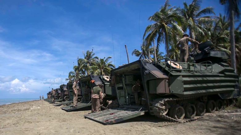 U.S. Marines assigned to Easy Company, Battalion Landing Team, 2nd Battalion, 2nd Marine Regiment, let down ramps of Amphibious Assault vehicles after an amphibious transition from ship to shore at Tanduo Beach, Malaysia, May 30, 2016. The Marines are embarked with U.S. Sailors aboard the USS Ashland (LSD 48) in support of exercise Cooperation Afloat Readiness and Training. CARAT is a series of annual, bilateral maritime exercises between the U.S. Navy, U.S. Marine Corps and the armed forces of nine partner nations to include Bangladesh, Brunei, Cambodia, Indonesia, Malaysia, Singapore, the Philippines, Thailand and Timor-Leste. The Ashland is assigned to U.S. 7th Fleet.  