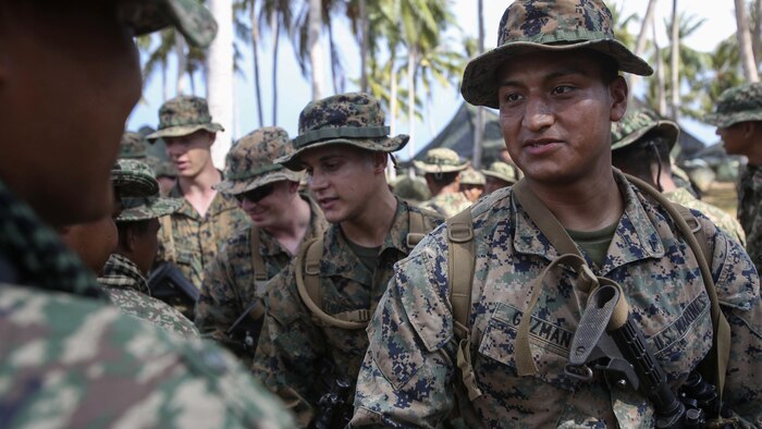 U.S. Marines assigned to Echo Company, 2nd Battalion, 2nd Marine Regiment, greet service members of the Royal Malay Army after an amphibious transition from ship to shore at Tanduo Beach, Malaysia, May 30, 2016. The Marines are embarked with U.S. Sailors aboard the USS Ashland (LSD 48) in support of exercise Cooperation Afloat Readiness and Training. CARAT is a series of annual, bilateral maritime exercises between the U.S. Navy, U.S. Marine Corps and the armed forces of nine partner nations to include Bangladesh, Brunei, Cambodia, Indonesia, Malaysia, Singapore, the Philippines, Thailand and Timor-Leste.The Ashland is assigned to U.S. 7th Fleet. 