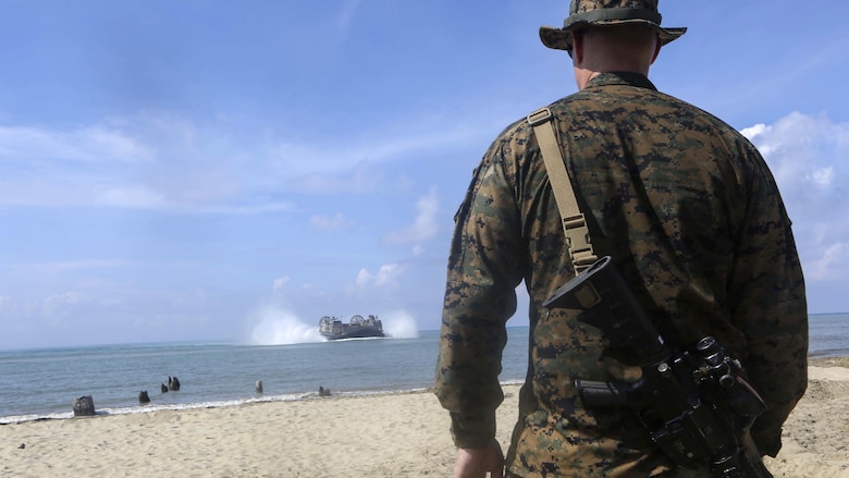 U.S. Marine Corps Major Sven Jensen, the Commander of troops for Easy Company, Battalion Landing Team 2nd Battalion, 2nd Marine Regiment watches as an landing craft air cushion brings in supplies during an amphibious transition from ship to shore at Tanduo Beach, Malaysia, May 30, 2016. The Marines of Echo Co., BLT, 2/2 are embarked with U.S. sailors aboard the USS Ashland (LSD 48) in support of exercise Cooperation Afloat Readiness and Training. CARAT is a series of annual, bilateral maritime exercises between the U.S. Navy, U.S. Marine Corps and the armed forces of nine partner nations to include Bangladesh, Brunei, Cambodia, Indonesia, Malaysia, Singapore, the Philippines, Thailand and Timor-Leste. The Ashland is assigned to U.S. 7th Fleet. 