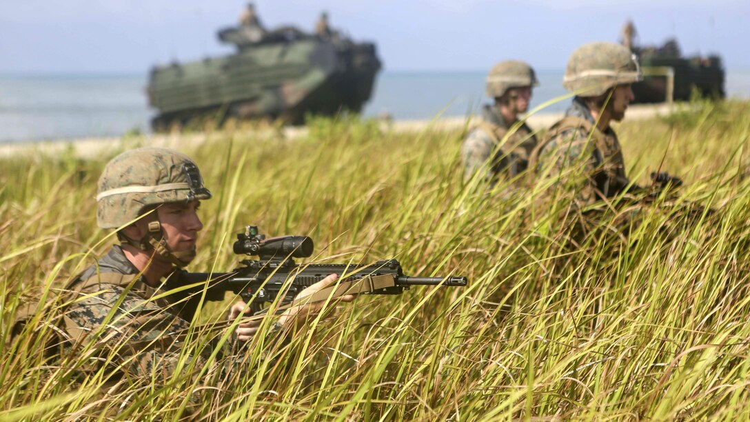 U.S. Marines assigned to Easy Company, Battalion Landing Team, 2nd Battalion, 2nd Marine Regiment post security after an amphibious transition from ship to shore at Tanduo Beach, Malaysia, May 30, 2016. The Marines are embarked aboard the USS Ashland (LSD 48) in support of exercise Cooperation Afloat Readiness and Training. CARAT is a series of annual, bilateral maritime exercises between the U.S. Navy, U.S. Marine Corps and the armed forces of nine partner nations to include Bangladesh, Brunei, Cambodia, Indonesia, Malaysia, Singapore, the Philippines, Thailand and Timor-Leste.The Ashland is assigned to U.S. 7th Fleet. 