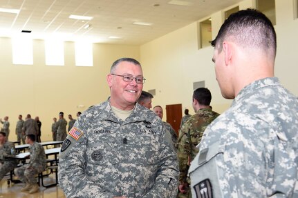 Army Reserve Sgt. Maj. James Rogers, Operations Sergeant Major, 85th Support Command, talks with a soldier from 3-335 Training Support Battalion during the unit's change of command ceremony, May 15. 2016, at Fort Sheridan, Illinois. 
(Photo by Spc. David Lietz)