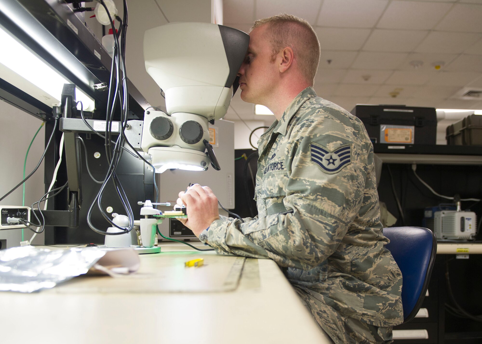 Staff Sgt. Kyle Eilefson, an Air Force Repair Enhancement Program technician with the 1st Special Operations Maintenance Squadron, solders resistors on a circuit board at Hurlburt Field, Fla., May 24, 2016. The circuit board is part of the power supply for the approach lighting system on the Hurlburt Field runway. (U.S. Air Force photo by Senior Airman Krystal M. Garrett) 
