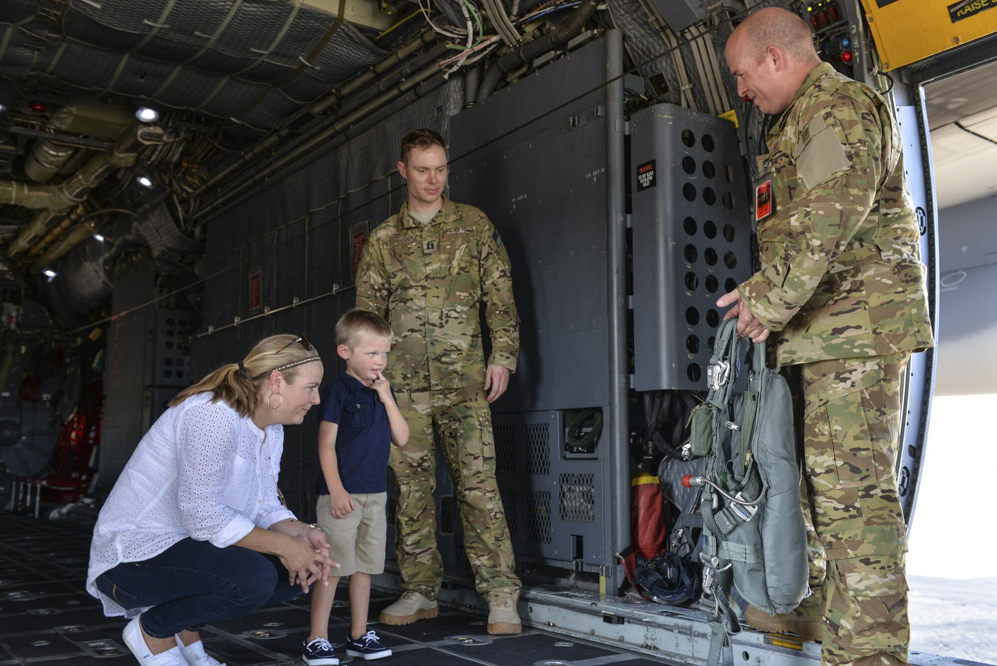 Four-year-old Carson Lester, second from left, contemplates trying on a parachute rig during his visit to the 15th Special Operations Squadron, Hurlburt Field, Fla., May 26, 2016. Lester is the star of a photograph taken during a family-photo session that was ‘photobombed’ by an MC-130H Combat Talon II and was invited to the 15th SOS to get an up-close look at a Talon II.