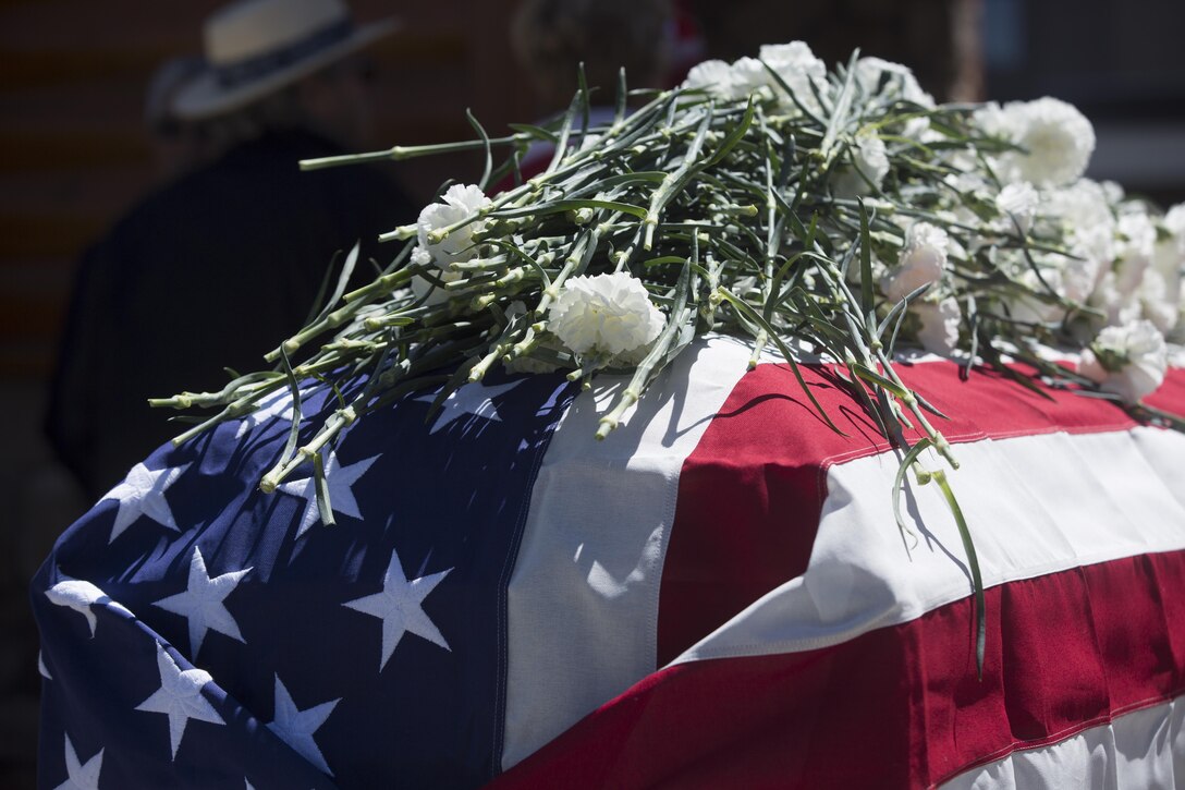 Carnations lay atop a casket as a sign of respect during the Memorial Day Ceremony in Veteran’s Park at Big Bear Lake, Calif., May 30, 2016. Sgt. Maj. Michael J. Hendges, Combat Center Sergeant Major, represented the Combat Center as the guest speaker in the Memorial Day Ceremony spoke about the importance of remembering the ultimate sacrifice many American service members have paid. (Official Marine Corps photo by Cpl. Medina Ayala-Lo/Released)
