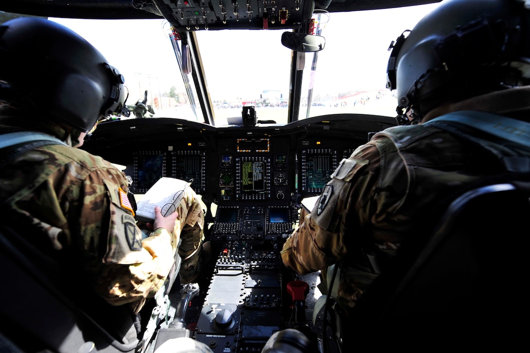 U.S. Army Chief Warrant Officer 4 Ronald Trani, Bravo Company 2-135th General Support Aviation Battalion CH-47 Chinook senior instructor pilot, and Chief Warrant Officer 2 Emily King, B Co 2/135th GSAB CH-47 Chinook pilot tactical operations officer, perform pre-flight checks April 1, 2016, at the Colorado School of Mines in Golden, Colo. The pre-flight checks ensure that the aircraft is safe and ready to fly and verify that there are no mechanical issues that would hinder the flight. (U.S. Air Force photo by Airman 1st Class Gabrielle Spradling/Released)