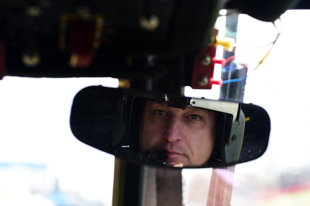 U.S. Army Chief Warrant Officer 4 Ronald Trani, Bravo Company 2-135th General Support Aviation Battalion CH-47 Chinook senior instructor pilot, looks into a rearview mirror April 1, 2016, at the Colorado School of Mines in Golden, Colo. Instructor pilots are responsible for training pilots on base mission tasks and upgrading them from readiness level one to readiness level three. (U.S. Air Force photo by Airman 1st Class Gabrielle Spradling/Released)