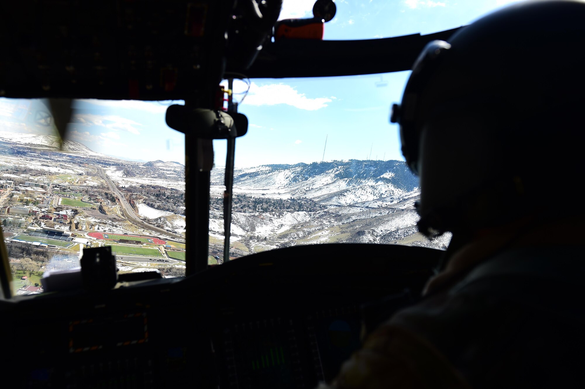 U.S. Army Chief Warrant Officer 4 Ronald Trani, Bravo Company 2-135th General Support Aviation Battalion CH-47 Chinook senior instructor pilot, flies through a passApril 1, 2016, during a flight over Denver. Instructor pilots administer check rides to pilots to ensure safety standards are met. (U.S. Air Force photo by Airman 1st Class Gabrielle Spradling/Released)