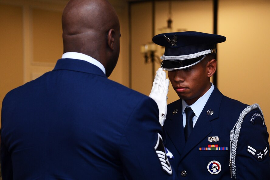 U.S. Air Force Airman 1st Class Justin Martinez, 20th Force Support Squadron honor guardsman, salutes an American flag presented to retired Master Sgt. Corey Taylor during Taylor’s retirement ceremony at Shaw Air Force Base, S.C., June 3, 2016. Retirees are traditionally presented with a folded American flag during their ceremony to thank them for their dedicated service to the United States of America. (U.S. Air Force photo by Senior Airman Jonathan Bass)