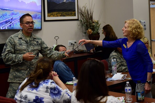 Cindy Darugna, Buckley Airman & Family Readiness Center Military Family Life counselor, provides Chief Master Sgt. Brian Cain, 460th Security Forces manager, with Military Family Life Counseling literature May 19, 2016, during a Hearts Apart event on Buckley Air Force Base, Colo. MFLC works with families, individuals, couples and children to provide non-medical problem identification and counseling services. (U.S. Air Force photo by Airman 1st Class Gabrielle Spradling/Released)