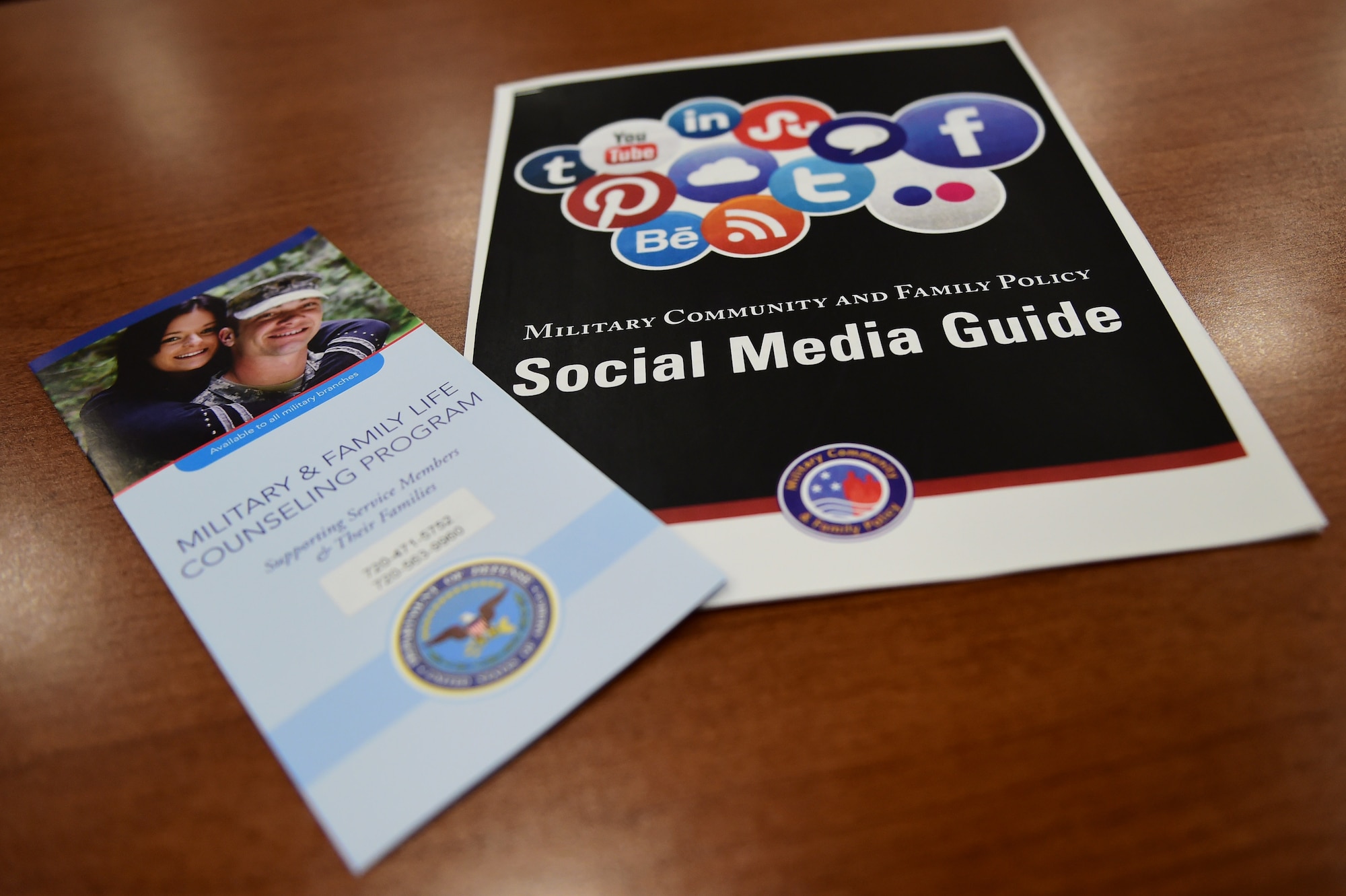 Social media and Military and Family Life Counseling Program pamphlets sit on the welcome table May 19, 2016, before a Heart Apart event on Buckley Air Force Base, Colo. The goal of the event was to provide support to military spouses and families, along with providing them information about services available on base. (U.S. Air Force photo by Airman 1st Class Gabrielle Spradling/Released)