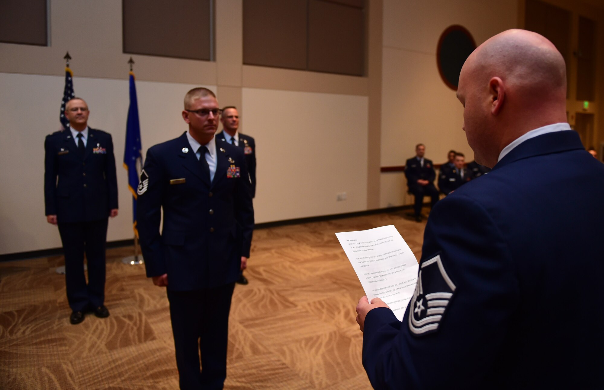Master Sgt. David Kechter, 460th Security Forces Squadron standards and evaluation superintendent , reads the senior noncommissioned officer creed May 31, 2016, to Buckley Air Force Base’s newest master sergeant, Master Sgt. Travis Rathje, 460th Space Communications Squadron plans and resources section chief, during the May promotion ceremony at the Leadership Development Center on Buckley AFB, Colo. The creed outlined what a senior NCO is and what is expected of them. (U.S. Air Force photo by Airman 1st Class Gabrielle Spradling/Released)