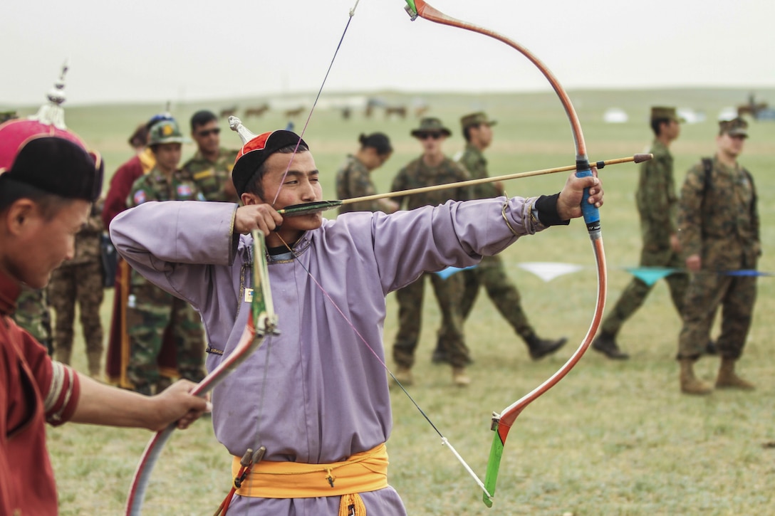 U.S. service members watch Mongolian archers demonstrate their archery skills during the Naadam festival as part of Khaan Quest 2016 outside Ulan Bator, Mongolia, June 3, 2016. The festival, featuring wrestling, archery and horseback-riding, is the last event for Khaan Quest participants to experience Mongolian culture before the closing ceremony June 4. Navy photo by Petty Officer 3rd Class Markus Castaneda