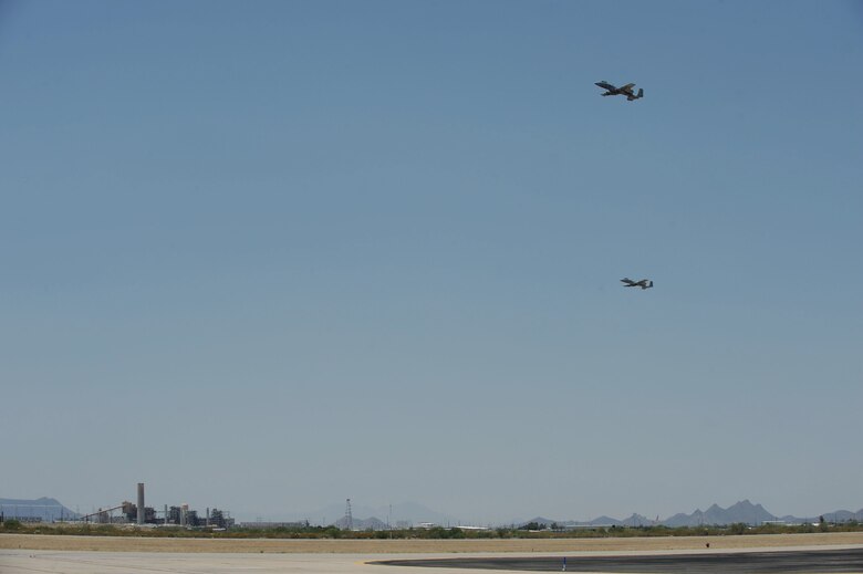 Two A-10C Thunderbolt IIs fly over the flight line during Hawgsmoke 2016 at Davis-Monthan Air Force Base, Ariz., June 1, 2016. D-M hosted the biennial competition which scores strafing accuracy, high-altitude dive-bombing, low-angle high-delivery, Maverick missile precision and team tactics. (U.S. Air Force photo by Airman 1st Class Ashley N. Steffen/Released)
