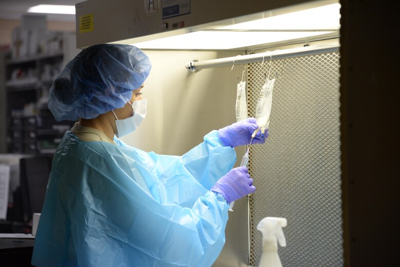 Senior Airman Ashley Deason, 60th Diagnostics and Therapeutics Squadron pharmacy technician, prepares an intravenous solution at Travis Air Force Base, Calif., May 24, 2016. Deason works in the inpatient pharmacy at David Grant USAF Medical Center, which prepared more than 7,000 intravenous mixtures within the month of April for patients admitted to hospital rooms. (U.S. Air Force photo by Senior Airman Amber Carter)