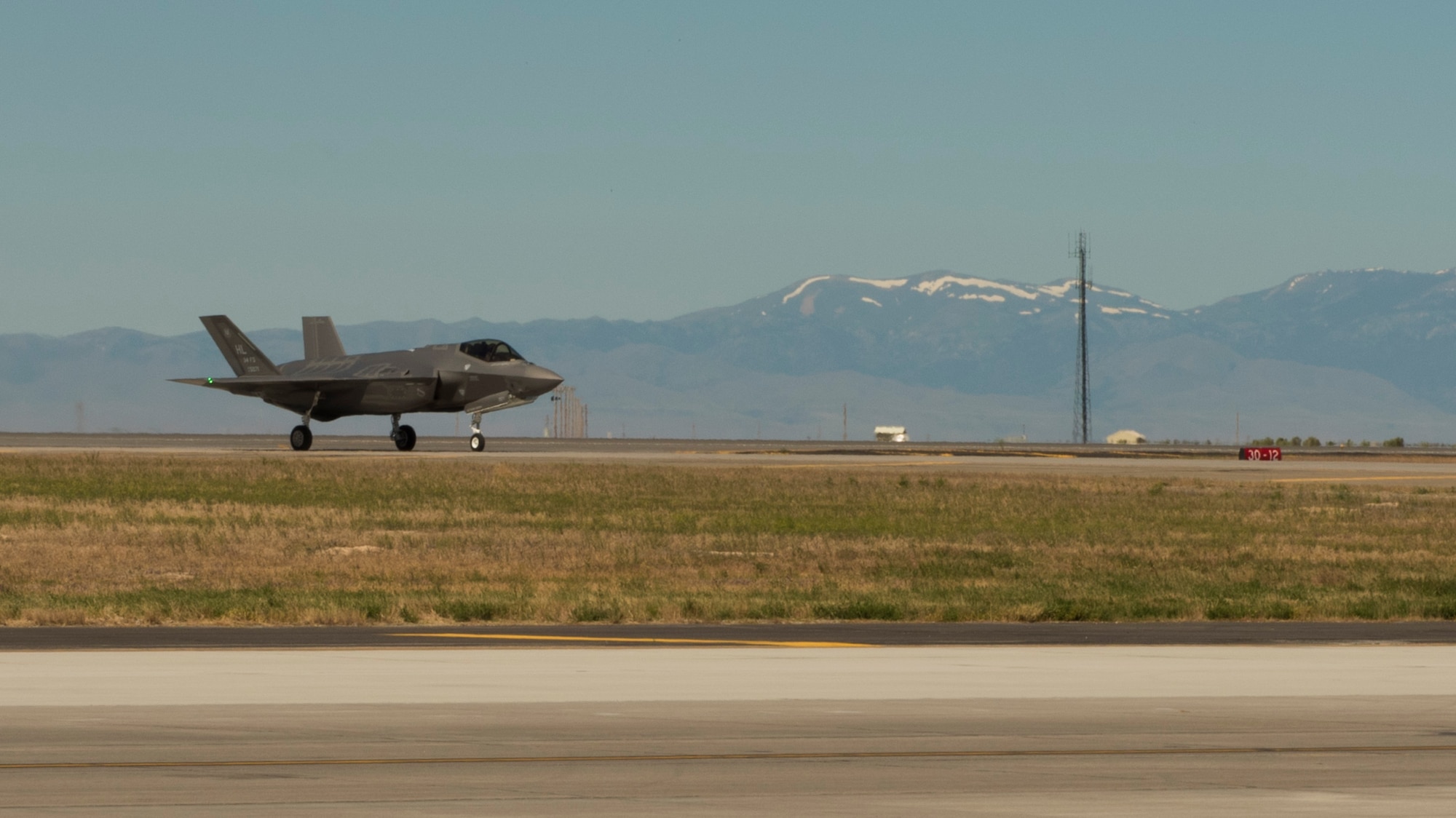An F-35A lands on the runway at Mountain Home Air Force Base, Idaho, June 3, 2016. The mock deployment to Idaho marks the first out-of-state training mission for Hill Air Force Base's operational 5th generation aircraft. (U.S. Air Force Photo by Airman Alaysia Berry/RELEASED)