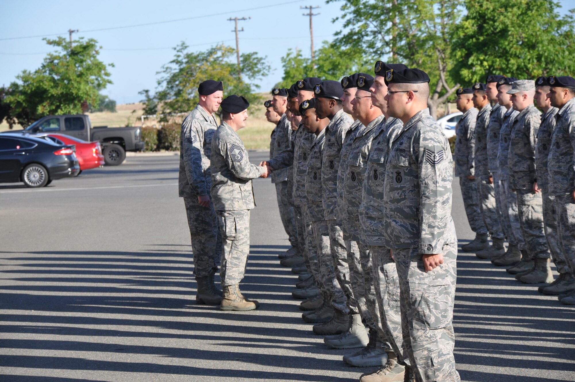 Chief Master Sgt. Bill Williams, 940 Security Forces Manager, takes an opportunity to shake hands with members of his squadron at Beale Air Force Base, California during Guard Mount formation at the May, 2016 Reserve Unit Training Assembly. Guard Mount is a structured formation used to address members of the unit and ensure they are fit for duty. (U.S. Air Force photo by Maj. Dennis Hale)  
