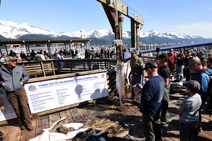 Spectators crowd around the official weigh-in point for the 10th Annual Armed Services Combat Fishing Tournament in Seward, Alaska, May 26. The tournament, hosted by the city of Seward and the Armed Services YMCA, gave more than 200 military anglers stationed in Alaska a free day of halibut fishing to thank them for their service. 