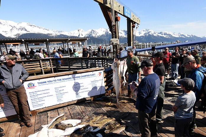 Spectators crowd around the official weigh-in point for the 10th Annual Armed Services Combat Fishing Tournament in Seward, Alaska, May 26. The tournament, hosted by the city of Seward and the Armed Services YMCA, gave more than 200 military anglers stationed in Alaska a free day of halibut fishing to thank them for their service. 