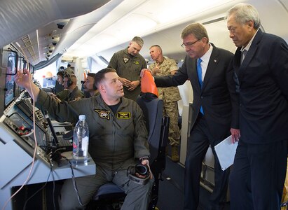 SINGAPORE (June 3, 2016) Secretary of Defense Ash Carter and Singapore Minister of Defence Minister NG Eng Hen are briefed on the capabilities of a P-8 during a flight over Singapore and the Strait of Malacca, June 3, 2016. Carter is in Singapore attending the 15th International Institute for Strategic Studies Asia Security Summit. 