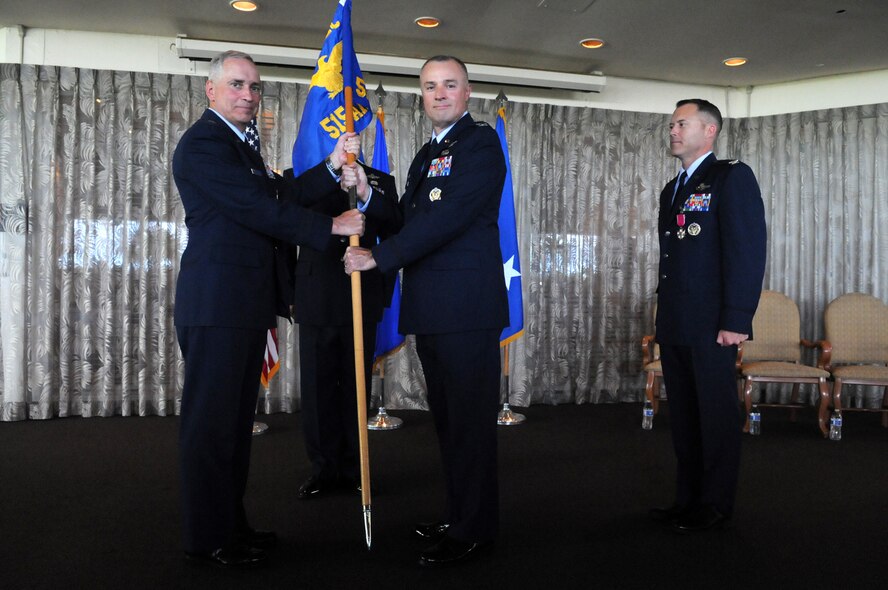 Colonel Scott C. Zippwald, incoming Commander, accepts the unit guidon from Major General Frederick H. Martin, Commander, U.S. Air Force Expeditionary Center, Joint Base McGuire-Dix-Lakehurst, New Jersey during the 515th Air Mobility Operations Wing change of command ceremony on 2 June 2016 at Joint Base Pearl Harbor-Hickam, Hawaii. Photo by David D. Underwood, Jr.