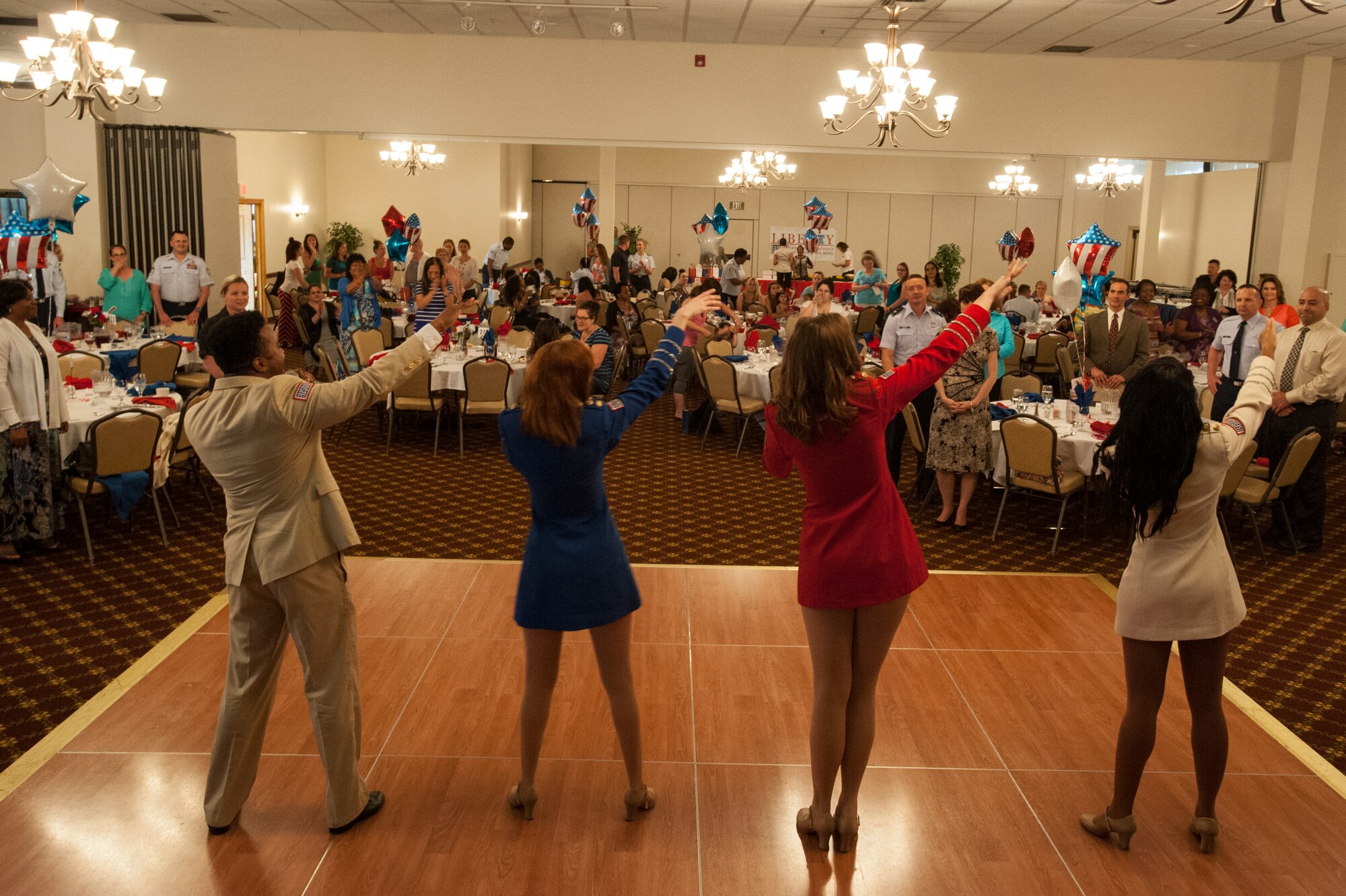 The United Service Organizations Show Troupe from New York sing and dance at the Spouse Appreciation Luncheon at Tommy B’s Community Center at Joint Base McGuire-Dix-Lakehurst, June 1, 2016. The Spouse Appreciation Luncheon is held annually to show appreciation for military spouses. (U.S. Air Force photo by Airman 1st Class Zachary Martyn/released)
