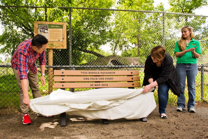 The 742nd Missile Squadron presented a custom engraved bench at the Roosevelt Park Zoo in Minot, N.D., May 26, 2016. The bench donated by the 742nd MS, aka The Wolf Pack, commemorates hundreds of volunteer hours and is appropriately positioned in front of the Grey Wolf exhibit. (U.S. Air Force photos/Airman 1st Class J.T. Armstrong)