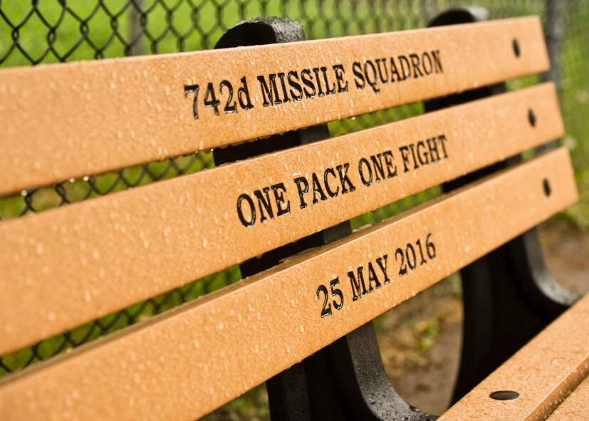The 742nd Missile Squadron presented a custom engraved bench at the Roosevelt Park Zoo in Minot, N.D., May 26, 2016. The bench donated by the 742nd MS, aka The Wolf Pack, commemorates hundreds of volunteer hours and is appropriately positioned in front of the Grey Wolf exhibit. (U.S. Air Force photos/Airman 1st Class J.T. Armstrong)
