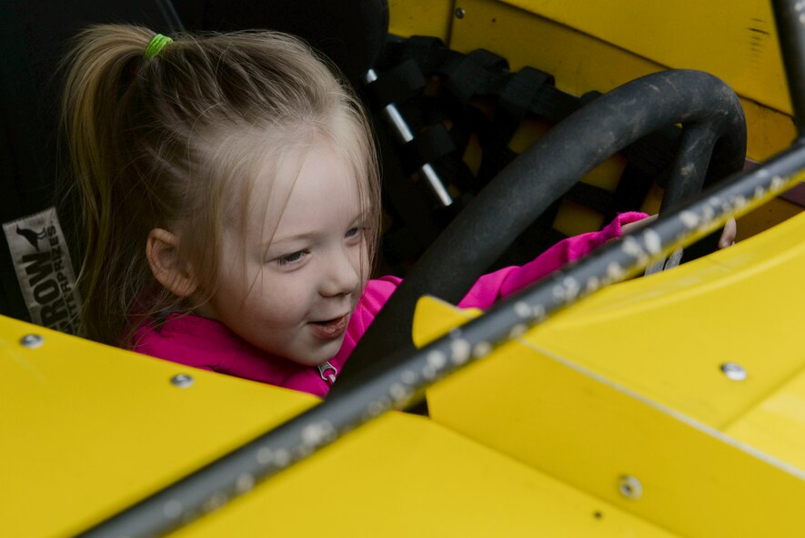A child sits in the driver’s seat of a racecar that visited Minot Air Force Base, N.D., May 25, 2016. Drivers were displaying cars, did some giveaways and informed Team Minot of the speedway events this summer and on May 30 for Military Appreciation Day. (U.S. Air Force photo/Airman 1st Class Jessica Weissman)