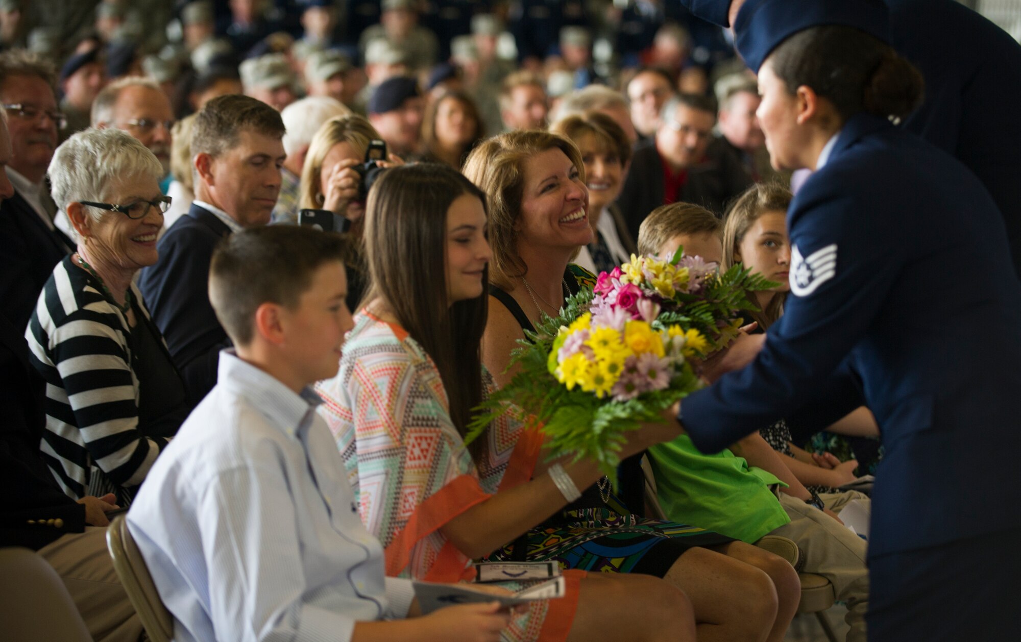 Family members of 5th Bomb Wing Ccommander, Col. Michael Brooks, accept flowers during the 5th BW change of command ceremony at Minot Air Force Base, N.D., June 3, 2016. Brooks came from Whiteman AFB, where he was the 509th Bomb Wing’s vice commander. (U.S. Air Force photo/Senior Airman Apryl Hall)