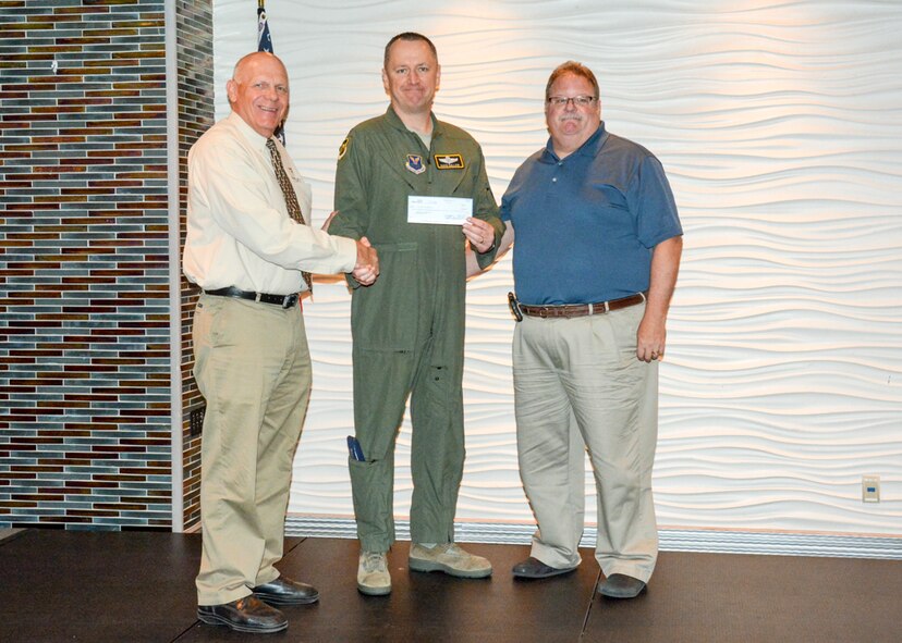 John MacMartin, Chamber of Commerce, presents Col. David Ballew, 5th Bomb Wing vice commander, a check from Prairie Warrior Auction for a total of $45,292.34 in Minot, N.D., June 2, 2016. The Prairie Warrior Auction consists of donations from downtown businesses, private donors and Team Minot generating profits that are used to provide funds for the base, wings and squadrons, promoting morale and welfare events throughout the year. (Courtesy Photo)