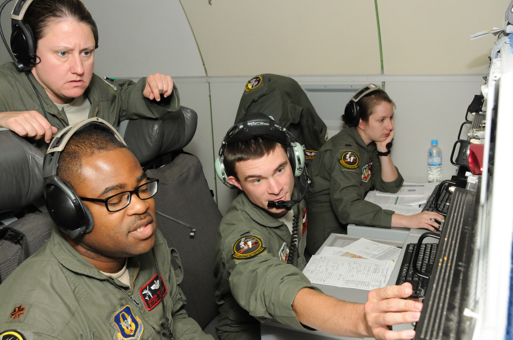 1st Lt. Nathaniel Metcalf, from the 964th Airborne Air Control Squadron, talks with Maj. Andrew Popoola, a Reservist from the 970th Airborne Air Control Squadron, on April 27 during a sortie in support of Max Thunder 16. The annual exercise involved nearly 2,000 U.S. and South Korean military personnel and included F-16 Fighting Falcons, F-18 Hornets, EA-18G Growlers and the latest Airborne Warning and Control System modification, the E-3G Sentry. (Courtesy photo/Released)